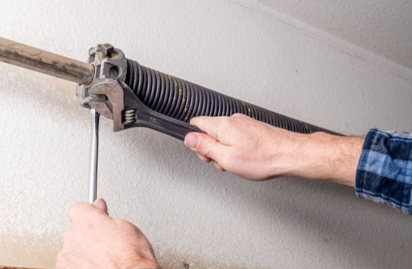 close up of a man working on garage door components