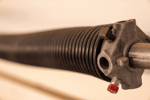 Garage door spring replacement service - close up of a garage door spring